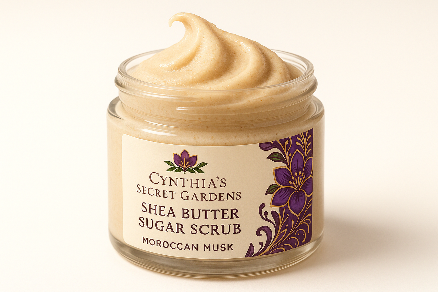 Please create a creamy Shea Butter sugar scrub Moroccan Musk using an African purple and gold african flower logo with green leaf make the jar clear and the scrub creamy coming out of the jar Please use Cynthia's Secret Gardenson th elabel